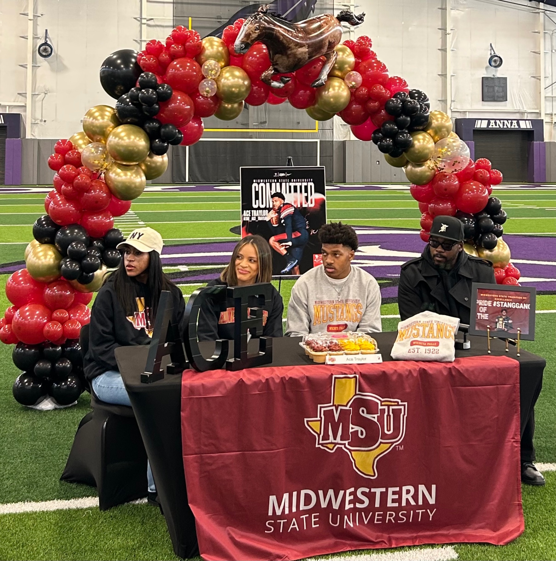Red, gold, and black Midwestern State signing arch