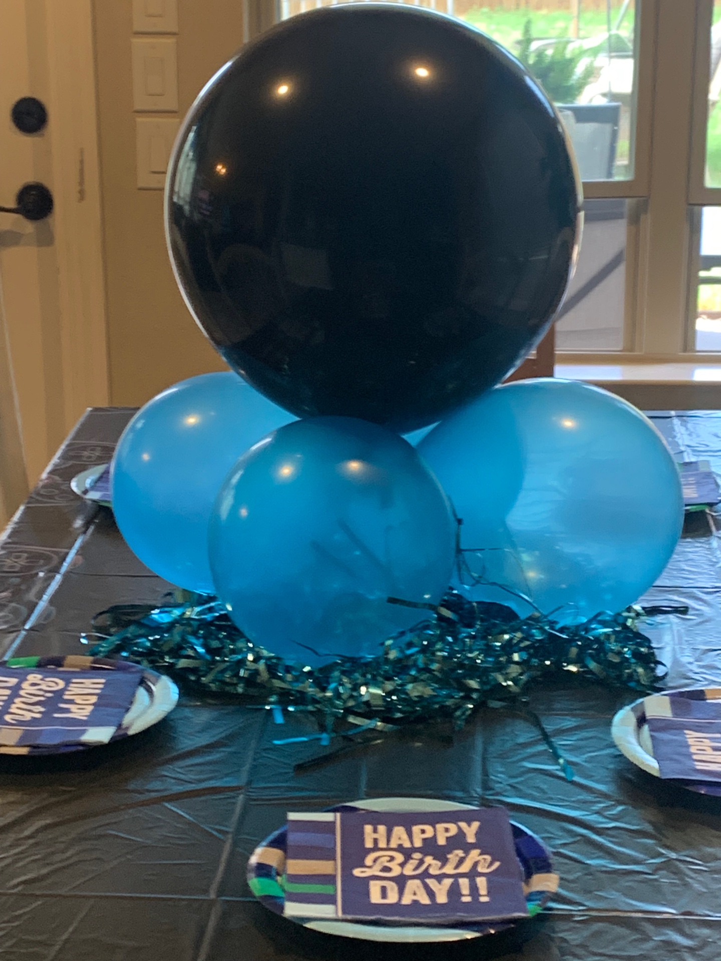 Black and blue balloon birthday table centerpiece with tinsel