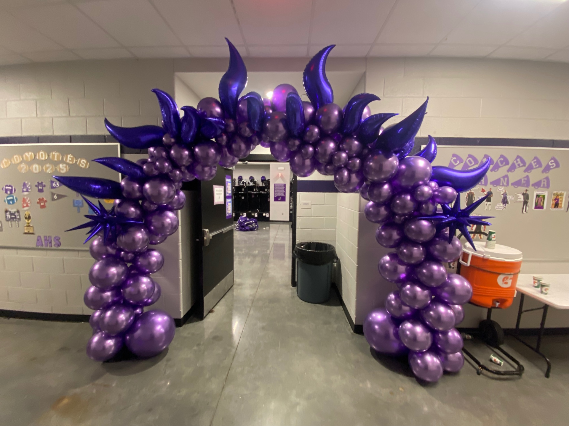 All-purple chrome balloon arch with flame and starburst foil accents