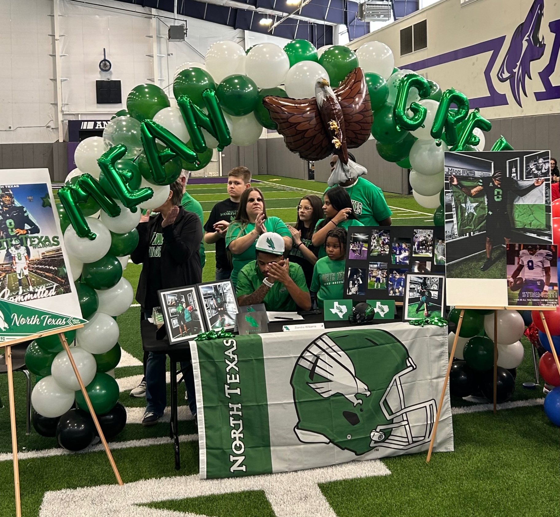 Green and white North Texas Mean Green signing arch