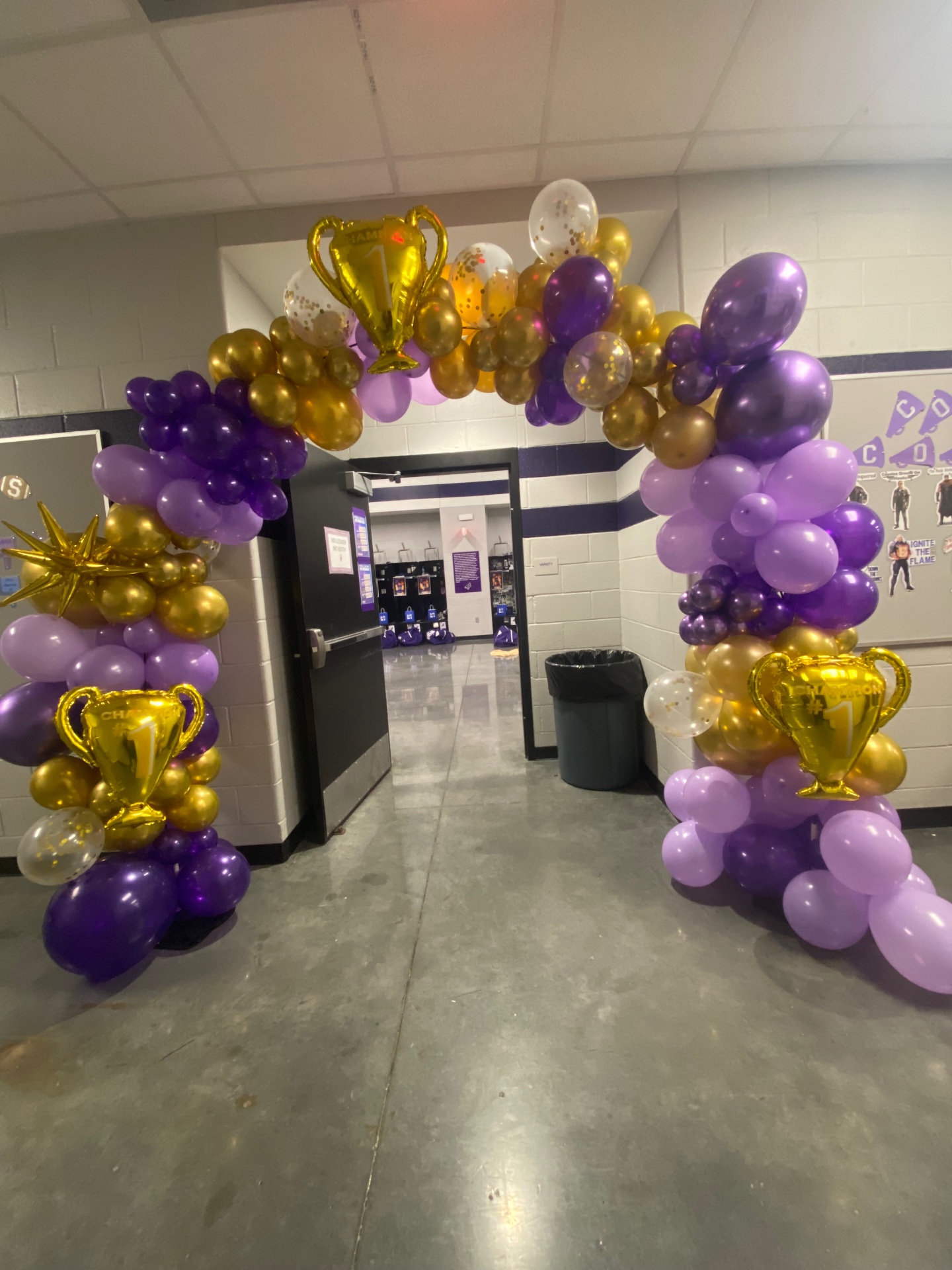 Purple, lavender, and gold champion trophy balloon arch with confetti balloons