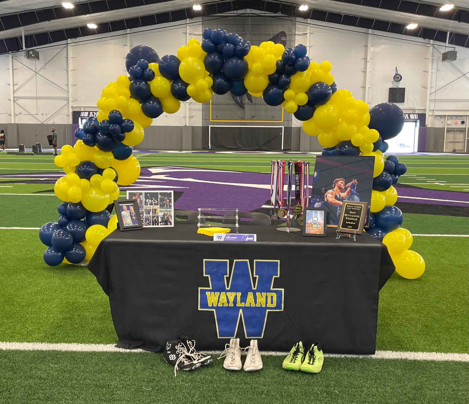 Navy and yellow balloon arch for Wayland signing day
